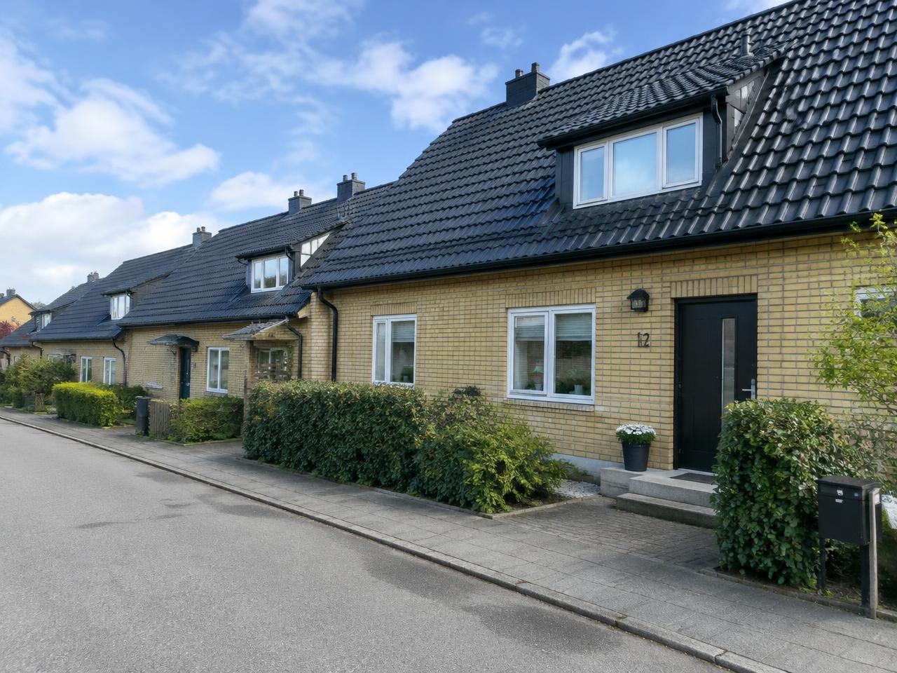 Svart tak och plåtbeslag på tegelhus